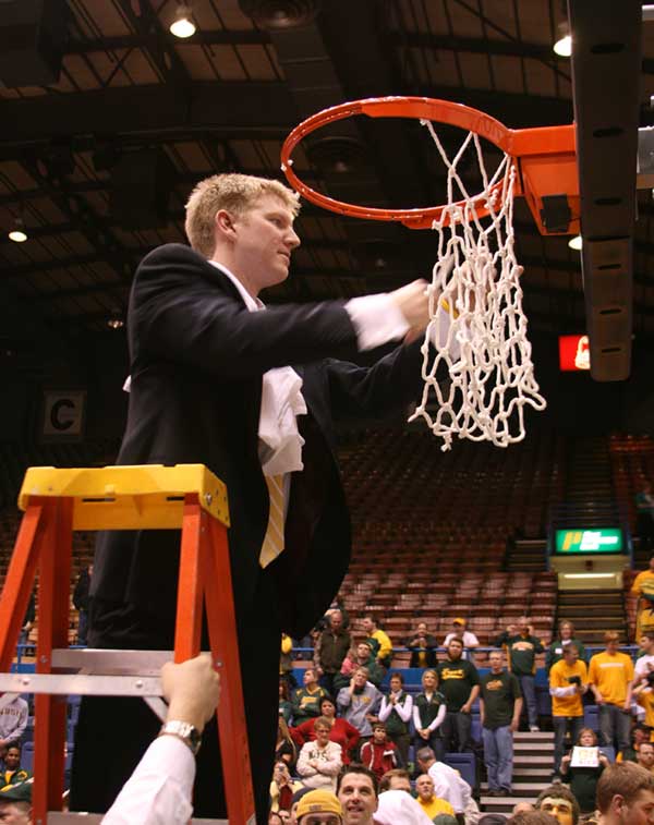 Coach Richman cutting down the net at the summit league championship