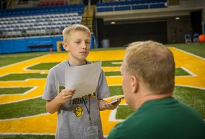 Colby asking his dad, Bison football head coach, about how the team is looking this spring. 