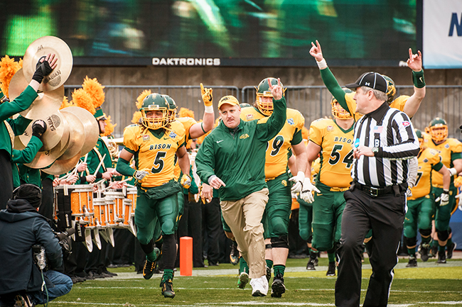 NDSU Bison head football coach Chris Klieman leads the Bison onto the field in Frisco, Texas.