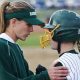 C.M. Russell's head softball coach Lindsey Graham gives a pep talk to Kylie Otis as they play Great Falls High at the Multi-Sports Complex Thursday.