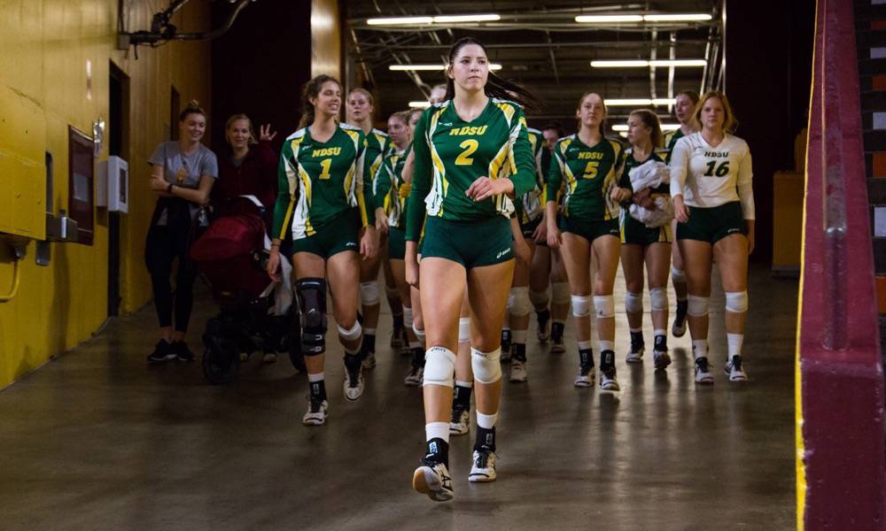 Allie Mauch leads her team onto the court before a game