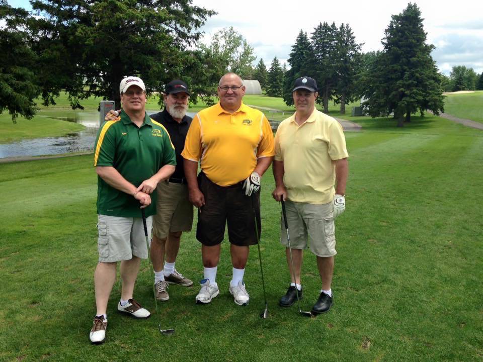 Some Team Makers members pose on a golf course while on an outing